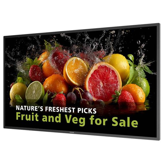 Philips 43BDL5050D commercial display at an angle; promotional fruit and vegetable artwork is illustrative.